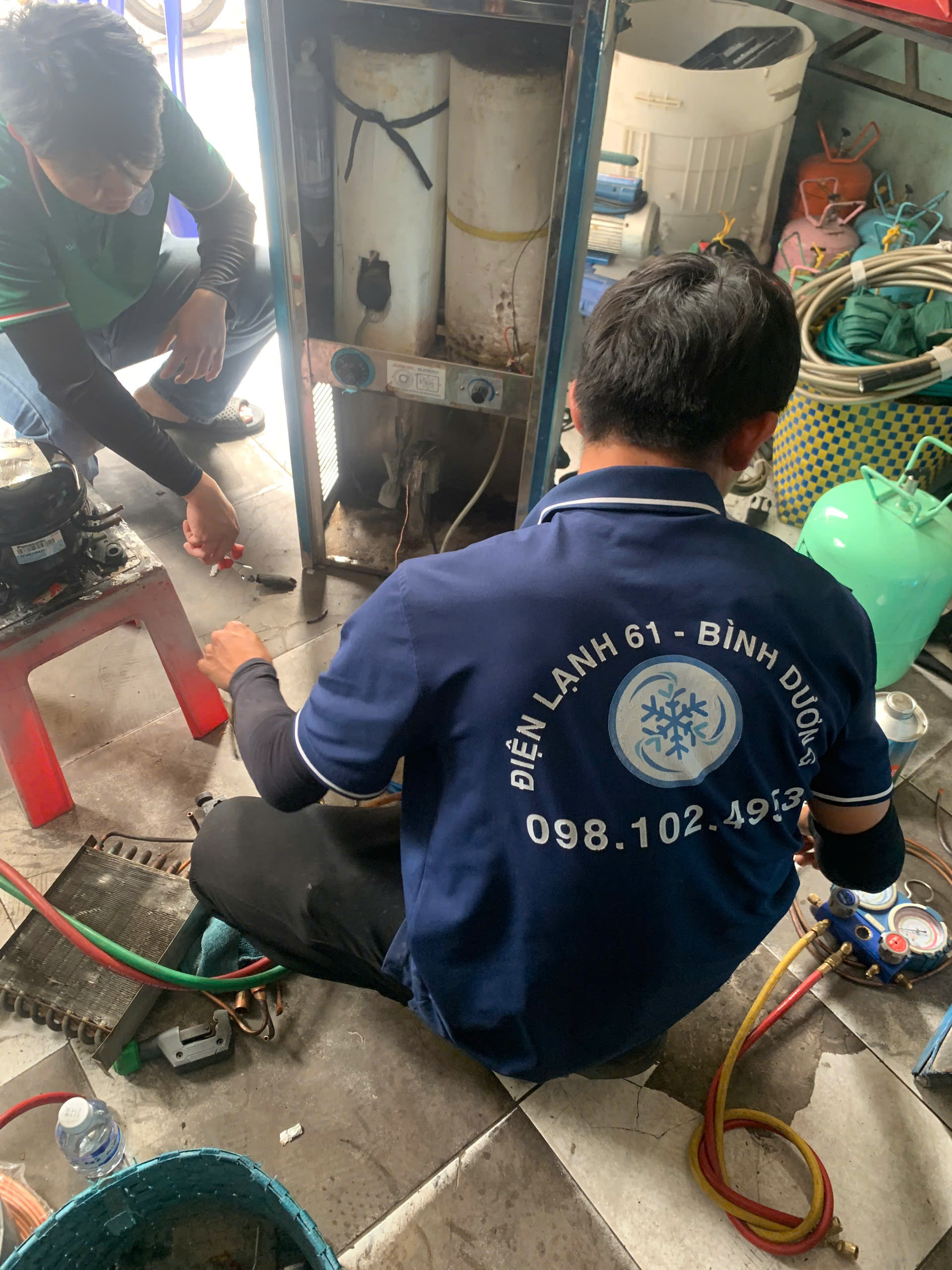 Tho-sua-may-loc-nuoc-Di-An-cua-Dien-Lanh-61-dang-kiem-tra-binh-ap-chua-nuoc Thợ sửa máy lọc nước Dĩ An của Điện Lạnh 61 đang kiểm tra bình áp chứa nước.