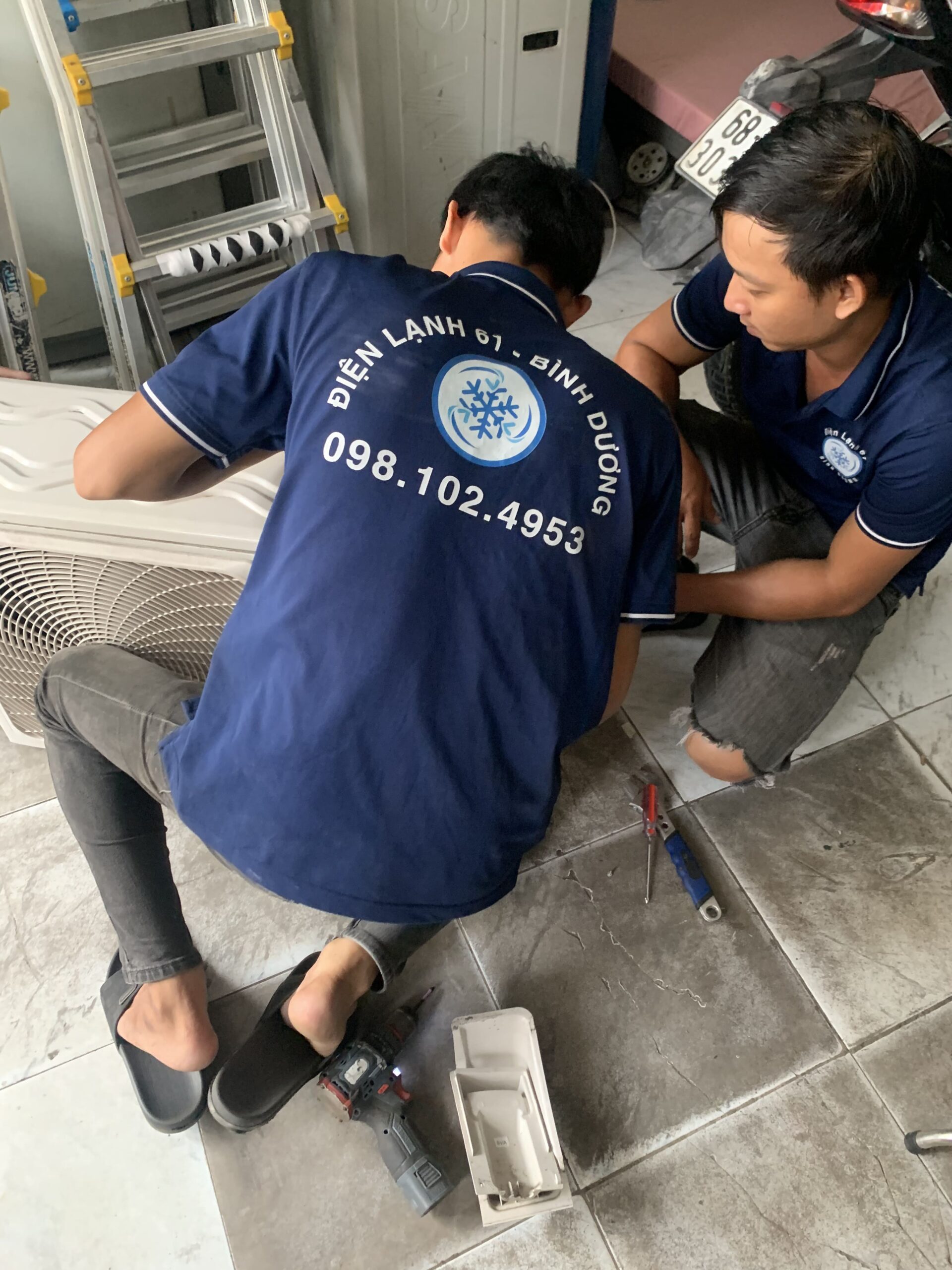 Thợ đang kiểm tra và nạp gas cho máy lạnh tại Linh Xuân - Dịch vụ sửa chữa chuyên nghiệp