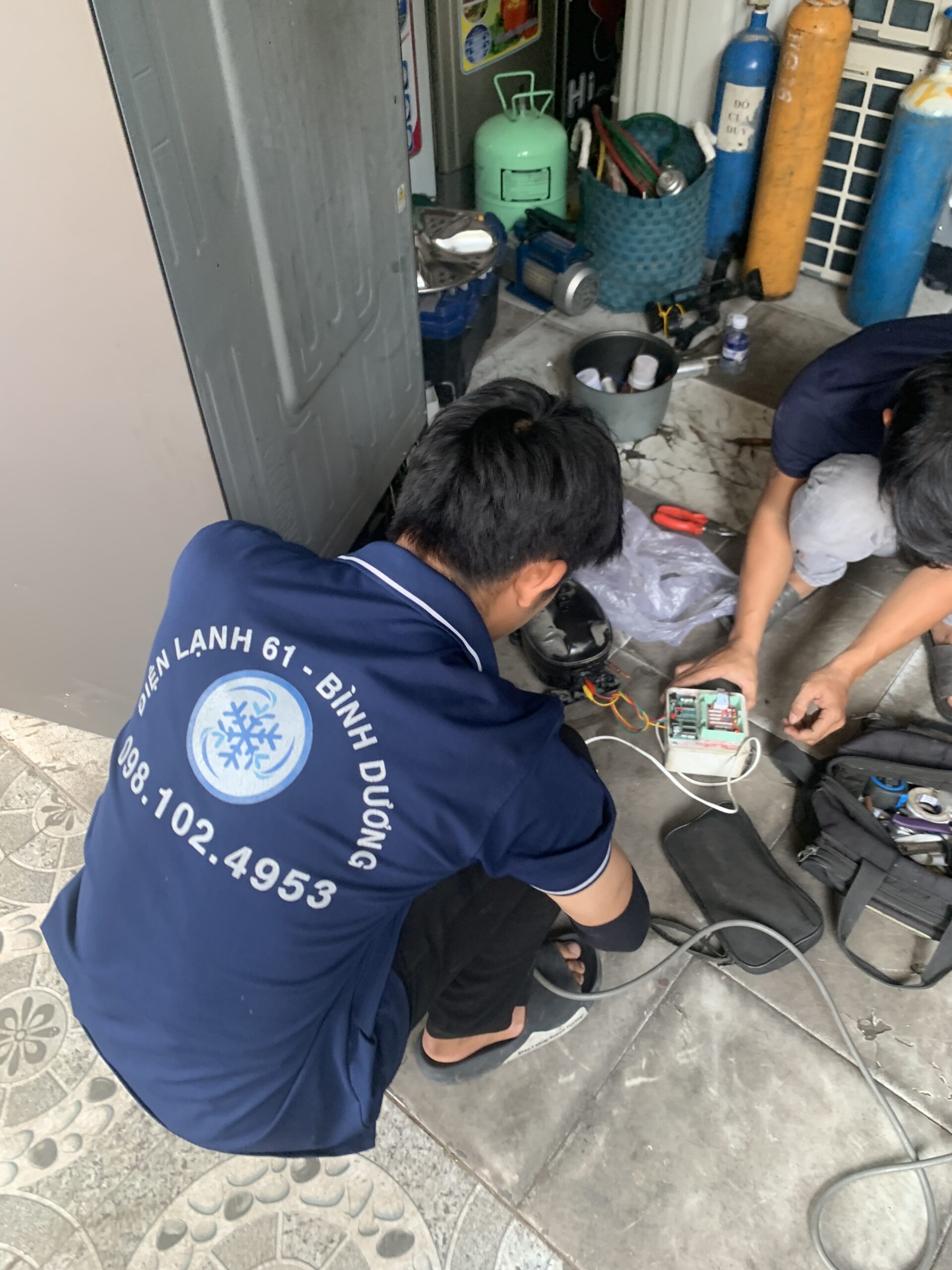 Ảnh kỹ thuật viên đang dùng máy khò hàn để bít kín lỗ thủng ống đồng